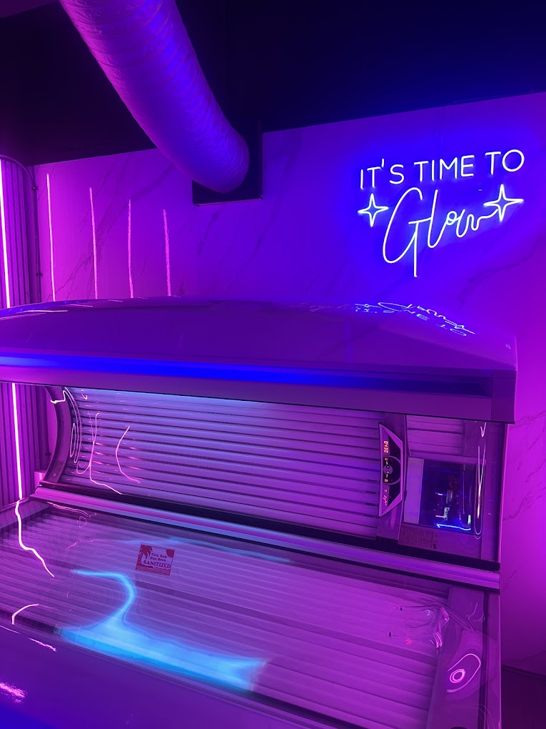 Ergoline 800 Turbo lie-down sunbed at Love Tan Warrington under neon 'It's time to glow' sign